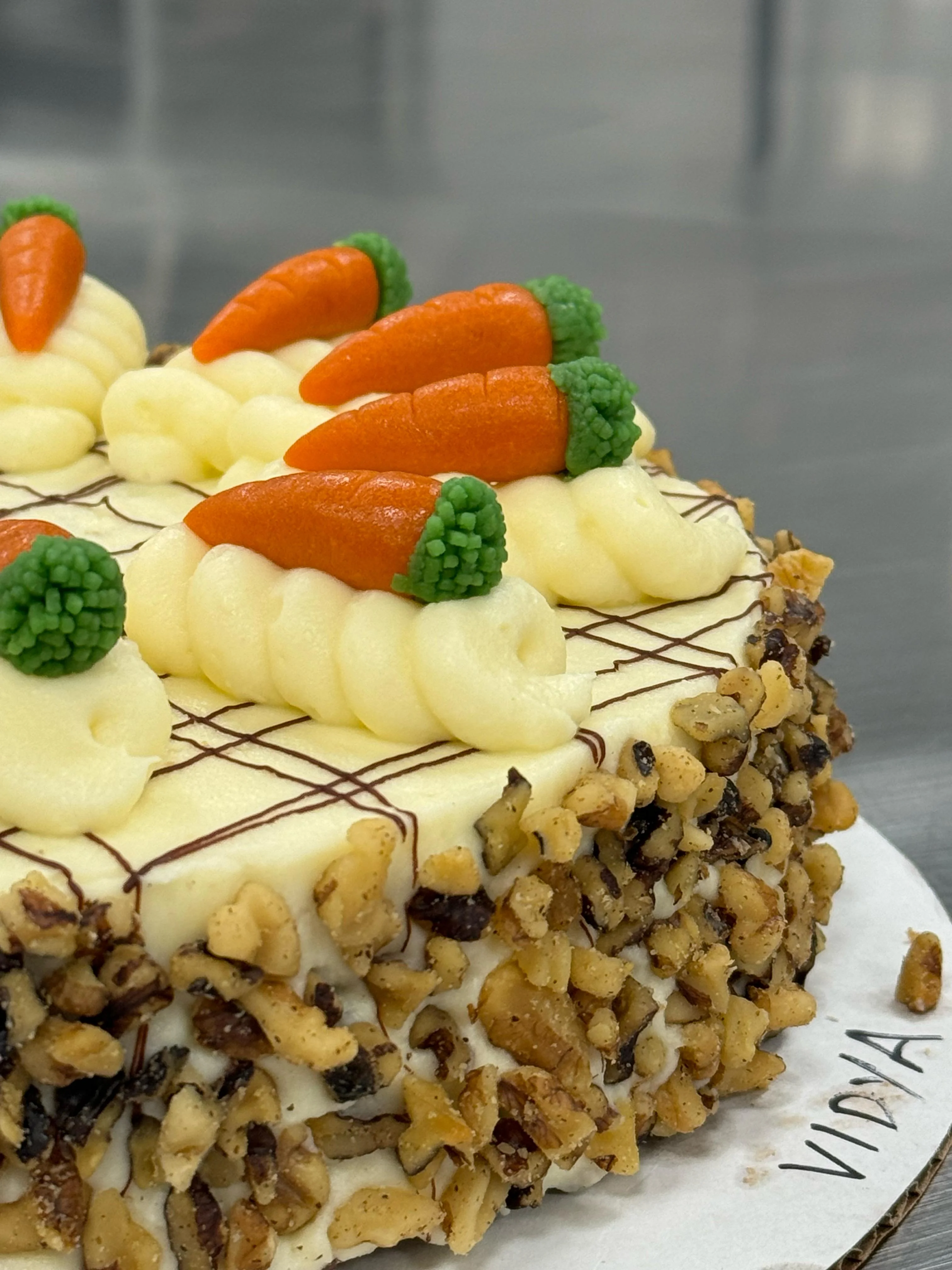 Gâteau Carotte — spiced carrot sponge in toasted walnuts with cream cheese frosting and marzipan carrots